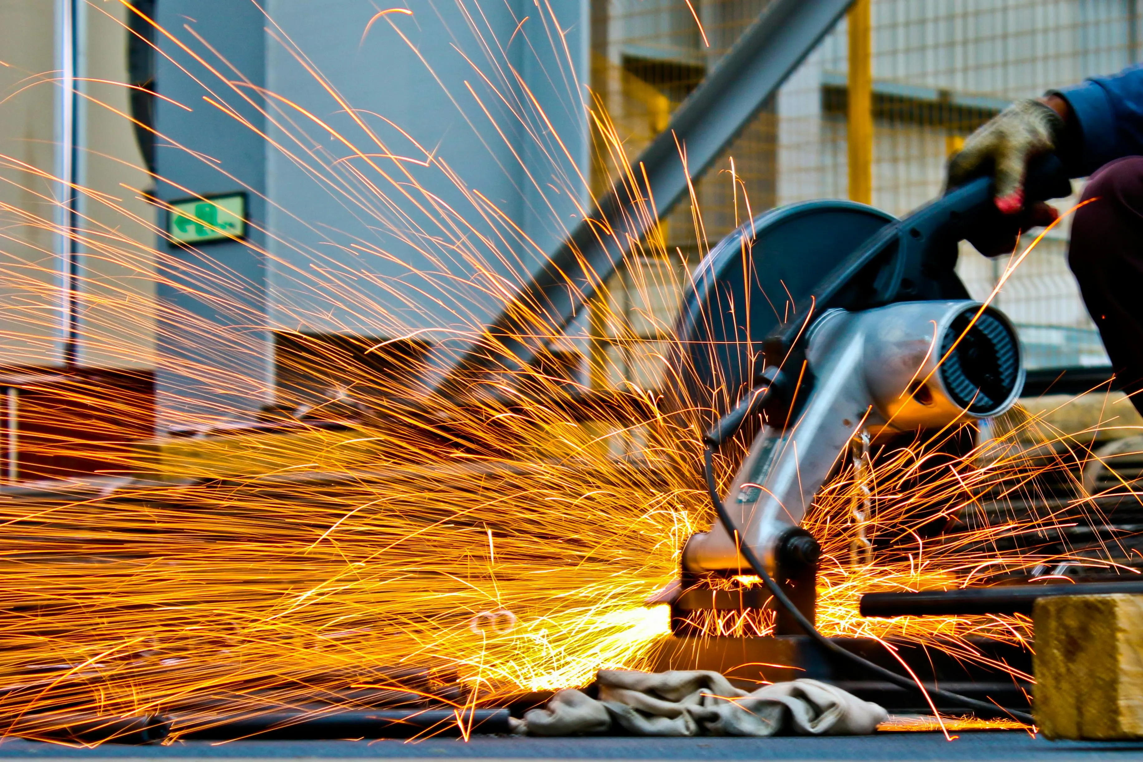 Angle grinder throwing sparks across steel